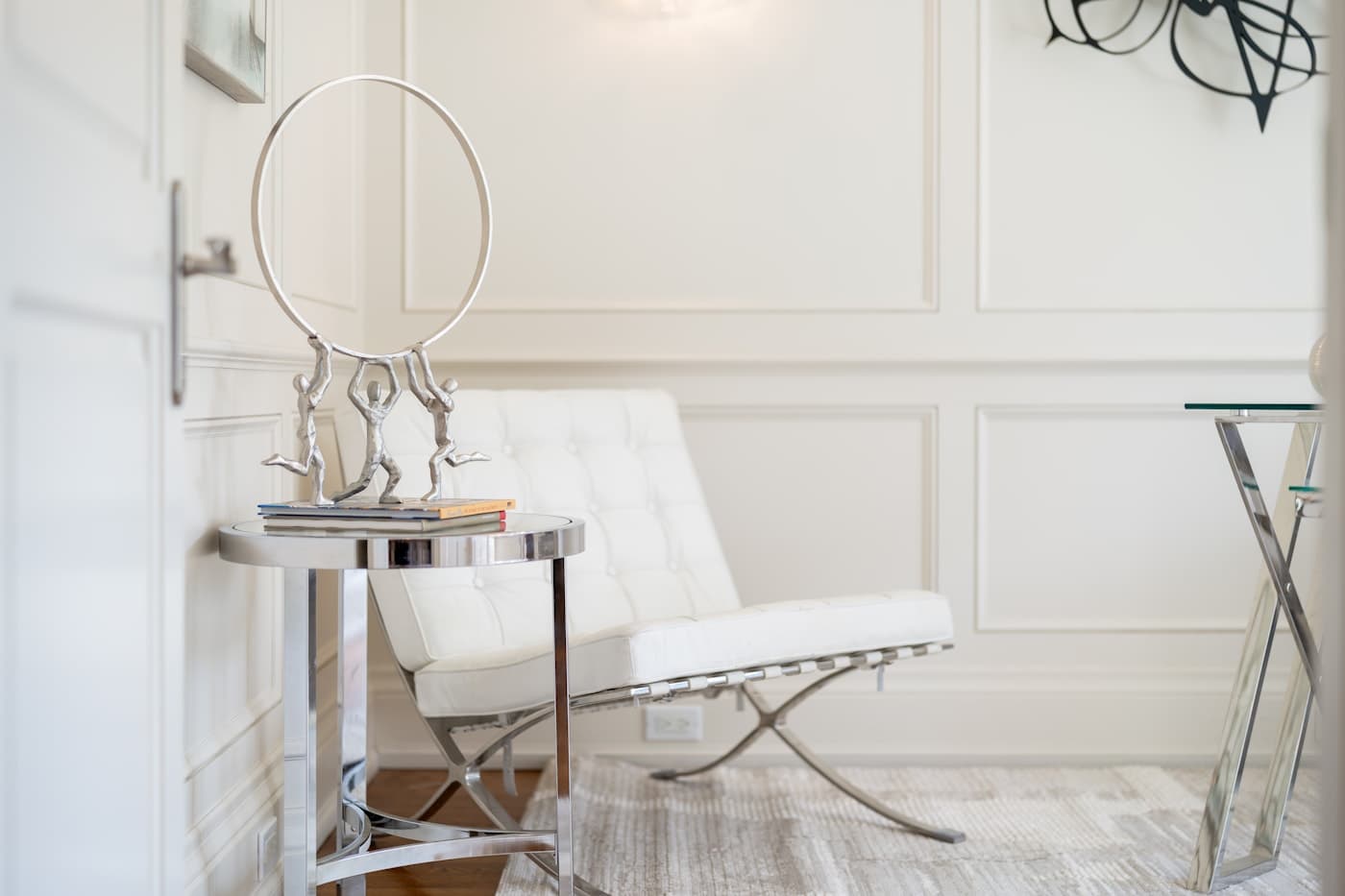 An elegant, minimal clinic room with a vanity mirror and soft seating